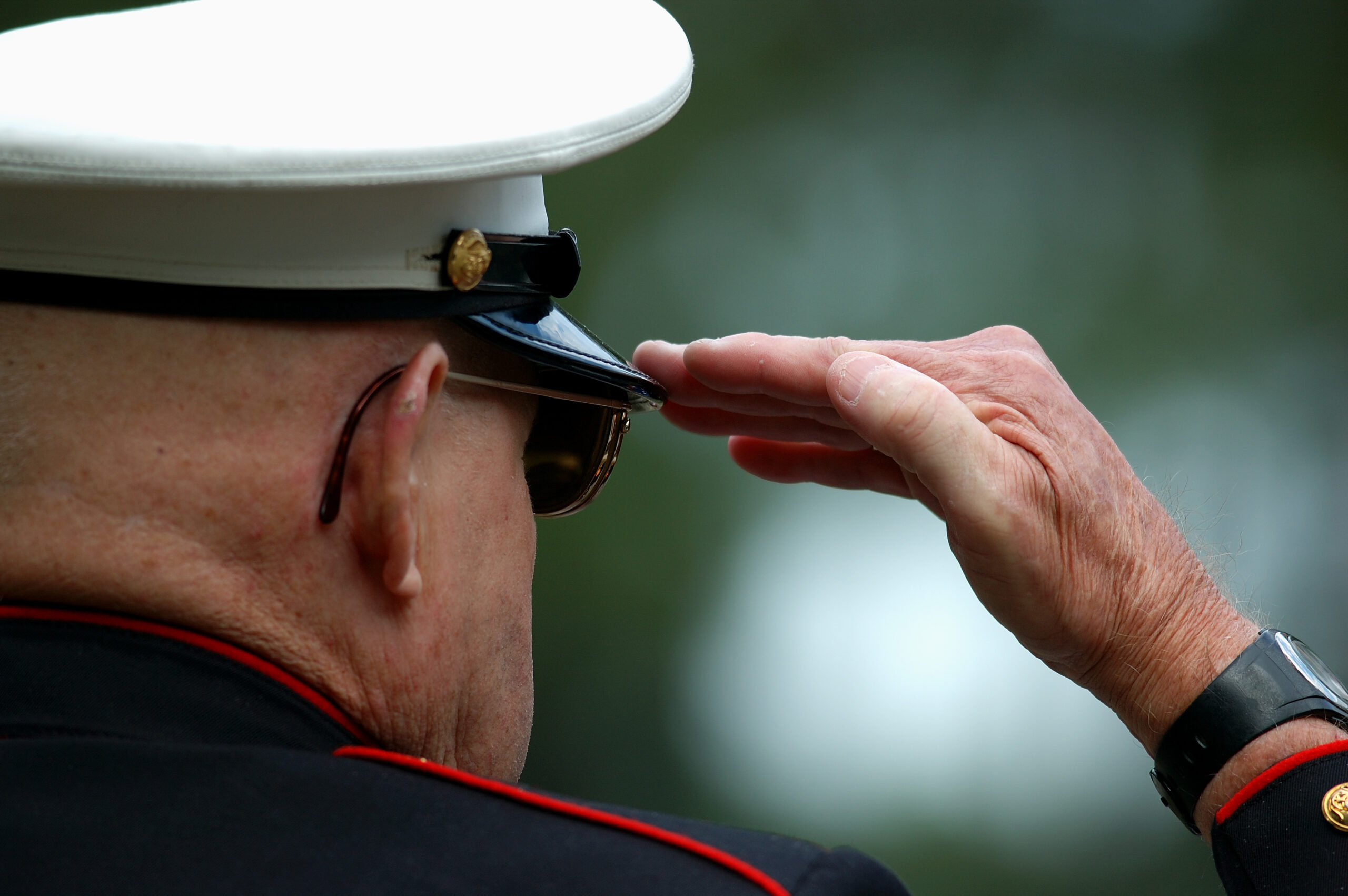 A senior veteran saluting.