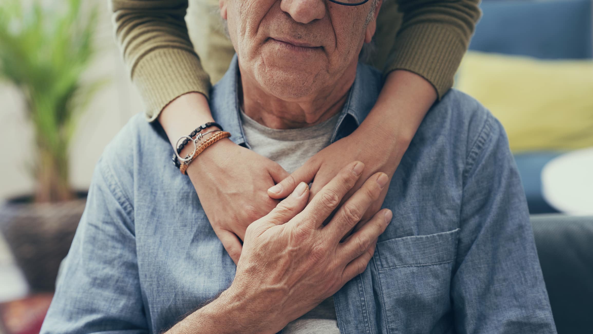 A senior being supported by a caregiver.